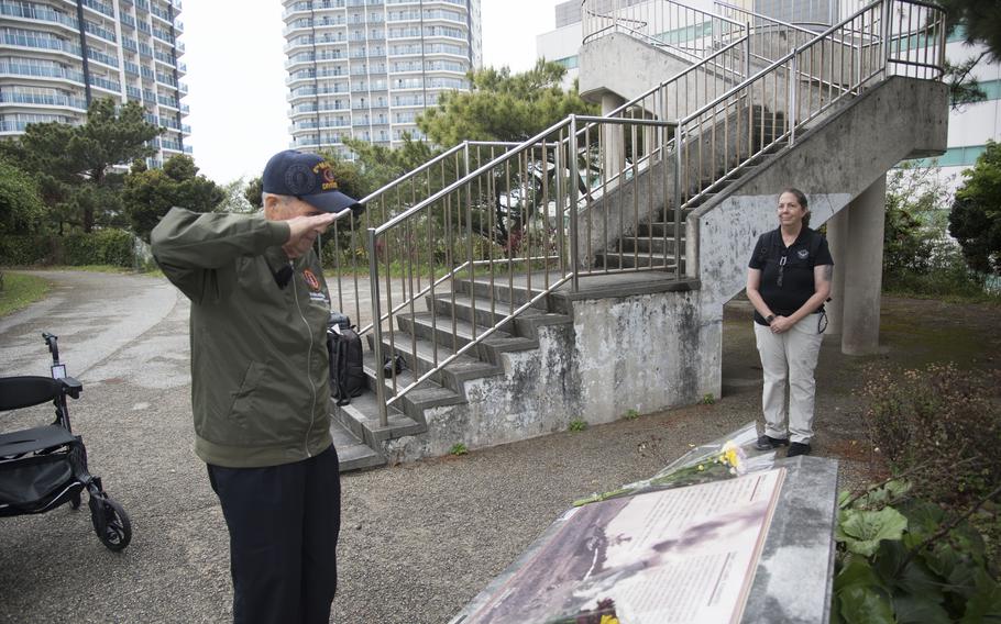 A WWII veteran salutes the memorial at Sugar Loaf Hill.