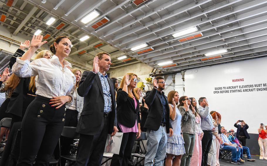 Sixty new Americans from 24 countries are sworn in as U.S. citizens during a naturalization ceremony aboard the USS Bataan on Tuesday, May 7, 2024. The Bataan was visiting Miami as part of its Fleet Week.