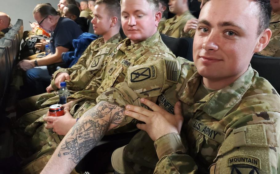 Retired Army Spc Geoffrey G Quevedo shows off one of his tattoos joking  that it cost him an arm and a leg at the unveiling of the Honoring Our  Fallen Memorial Wall