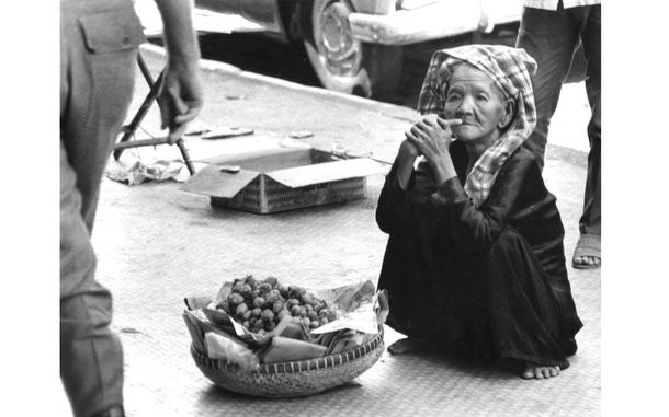 Saigon, January, 1966: A basket and a few feet of sidewalk make up this elderly woman's shop as she sells strawberries in downtown Saigon.

Looking for Stars and Stripes’ coverage of the Vietnam War? Subscribe to Stars and Stripes’ historic newspaper archive! We have digitized our 1948-1999 European and Pacific editions, as well as several of our WWII editions and made them available online through https://starsandstripes.newspaperarchive.com/

META TAGS: Vietnam War; Vietnamese; food; food vendor; daily life; 