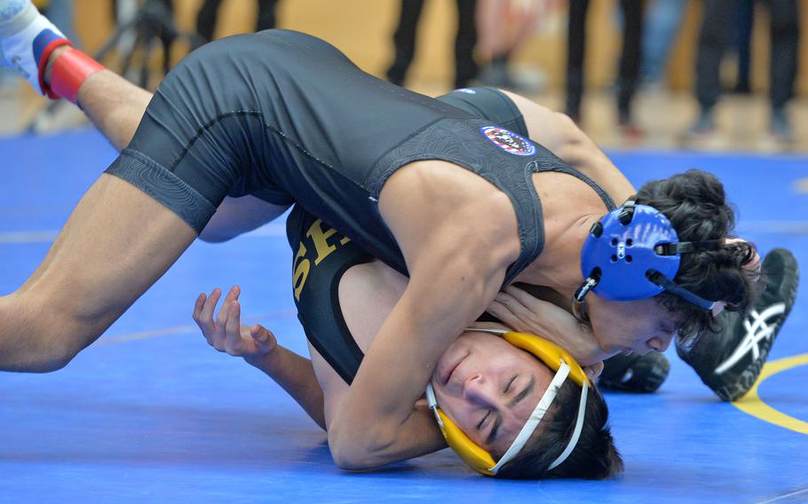 Ezra De Leon Kona of Brussels puts the pressure on Vicenza’s Erik Gastelum on his way to winning a 132-pound match on opening day of the DODEA-Europe wrestling finals in Wiesbaden, Germany, Feb. 10, 2023.