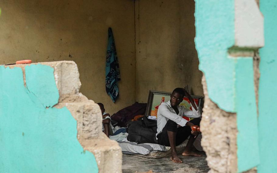 A family remains in a home damaged from the earthquake in Saint-Louis-du-Sud. 