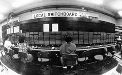 Yongsan, South Korea, April 1987. Operators sit side-by-side at the Stromberg-Carlson switchboard at Yongsan, South Korea, connecting local calls. The switchboard, used to switch local calls, was disconnected in April 1987 and was to be moved to the Signal Corps Museum at Fort Gordon, Georgia to make room for modern technology. META TAGS:  Yongsan Garrison; logistics; communication; telephone;