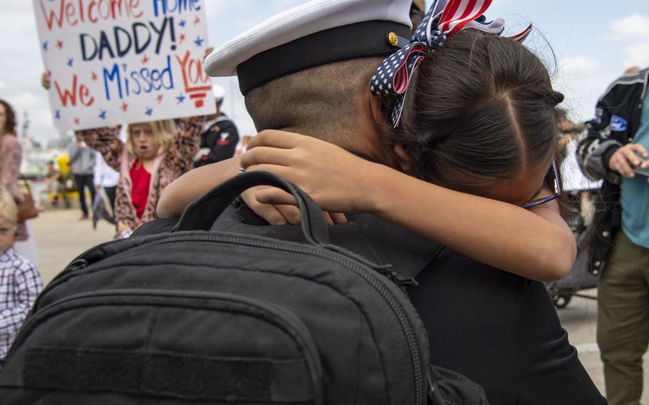 Chief Hull Technician Angel Alanis, assigned to amphibious assault carrier USS Tripoli (LHA 7), hugs his daughter upon Tripoli’s return to homeport, Tuesday, Nov. 29, 2022.