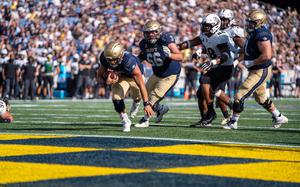 Quartaerback Tai Lavatai scores his first touchdown for Navy during the Midshipmen’s victory against Central Florida at Navy-Marine Corps Memorial Stadium in Annapolis, Md., Oct. 2, 2021.