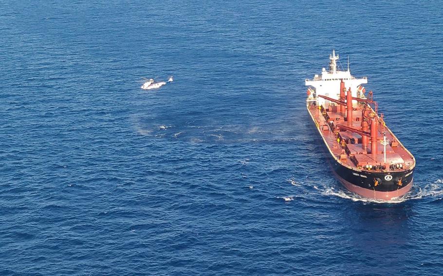 A Super Puma helicopter assigned to Combined Joint Task Force - Horn of Africa Personnel Recovery Task Force hovers near the cargo ship Liberty Grace during a complex, two-day medical evacuation from the Indian Ocean.