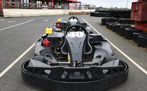 A 270cc kart is positioned in the pit on the 700 meter track at Red Lodge Karting in England. This kart is used for open practice sessions for the general public.