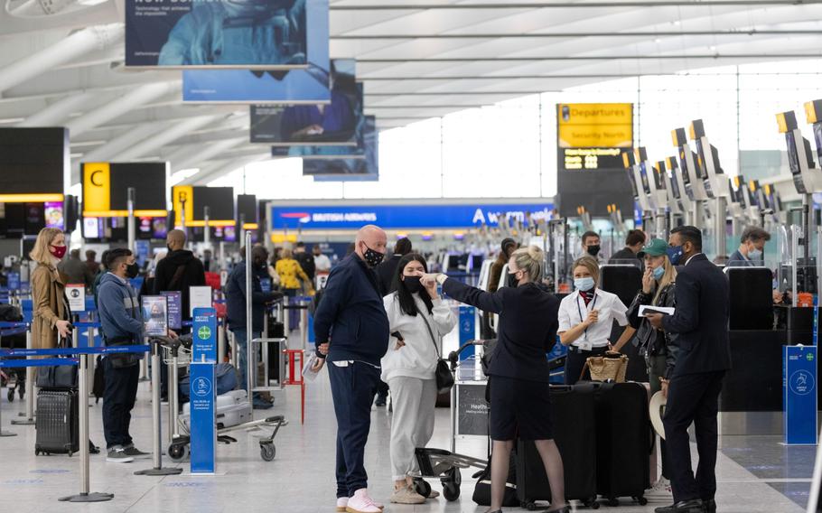 Passengers check in at London Heathrow on May 17, 2021.