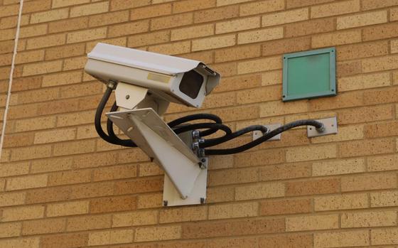 A security camera installed on a brick wall.
