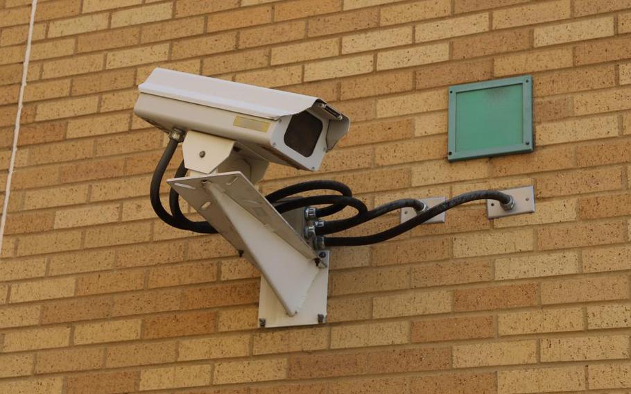 A security camera installed on a brick wall.