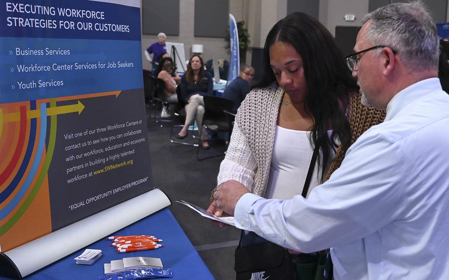 Shelby Barnes of Aberdeen, Maryland, left, talks with Mike Gali from the Susquehanna Workforce Network about potential jobs and other resources available through the organization at the Second Chance job fair at the Epicenter in Aberdeen, Maryland, on September 28, 2022. 