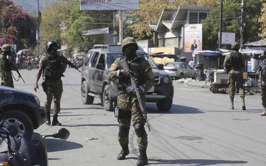 Members of the General Security Unit of the National Palace, USGPN, set up a security perimeter around one of the three downtown stations after police fought off an attack by gangs the day before, in Port-au-Prince, Haiti, Saturday, March 9, 2024. 