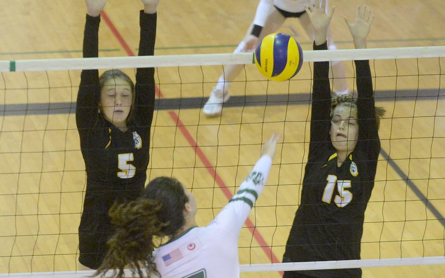 Kubasaki's Sophia Grubbs spikes against the double block of Kadena's Morgan Sayers and Marina Sawyer during Tuesday's Okinawa volleyball match. The Dragons beat the Panthers in straight sets for the 10th time this season.