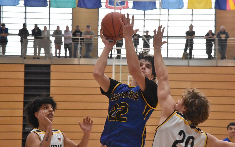 Wiesbaden’s Teagen McConville tries to score while defended by Stuttgart’s Ismael Anglada Paz, left, and Jacob Schudel in a Division I semifinal Friday, Feb. 16, 2024, at the DODEA European Basketball Championships in Wiesbaden, Germany.