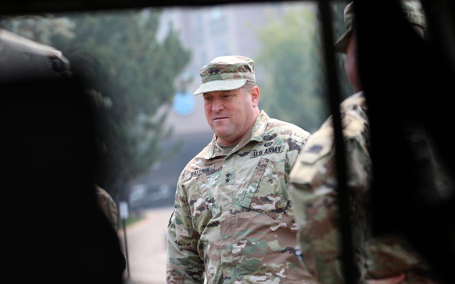 Viewed through a military humvee window, California National Guard Maj. Gen. David Baldwin, the adjutant general, listens to soldiers from 1st Battalion, 18th Cavalry Squadron, 79th Infantry Brigade Combat Team, who were activated to provide security during the Caldor Fire in El Dorado and Amador counties on Sept. 7, 2021. 