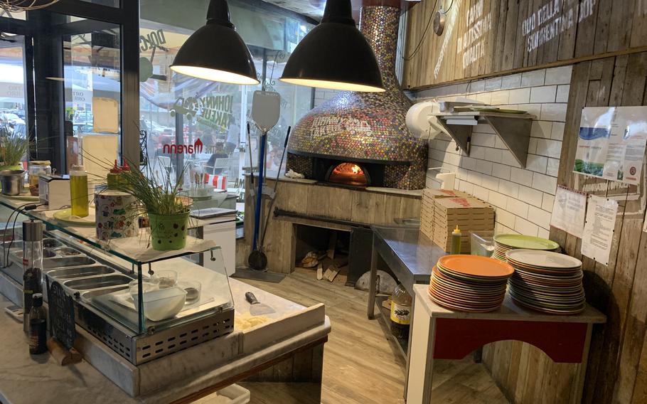 The kitchen at Johnny Take Ue features a colorful pizza oven. 