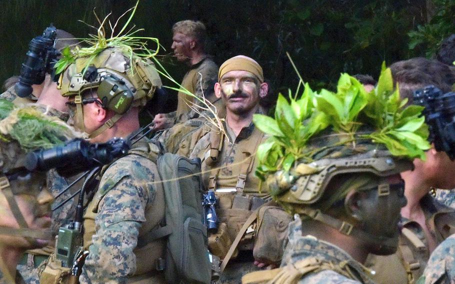 Marines from Alpha Company, 1st Battalion, 2nd Marine Regiment out of Camp Lejeune, N.C., prepare for an exercise at the Central Training Area on Okinawa, Dec. 7, 2022.