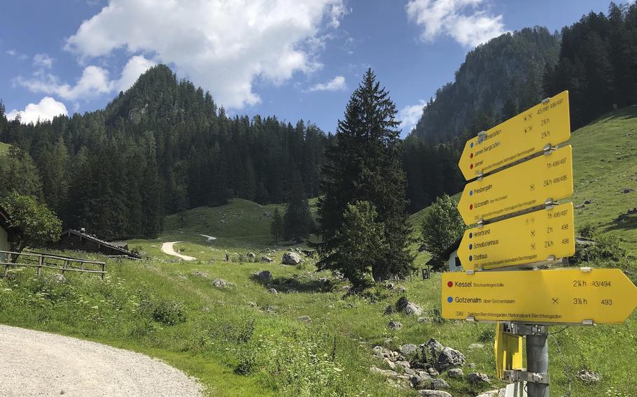 Signposts that provide estimated hiking times and degrees of difficulty appear along a trail in the Berchtesgaden National Park in Germany on June 27, 2022. 