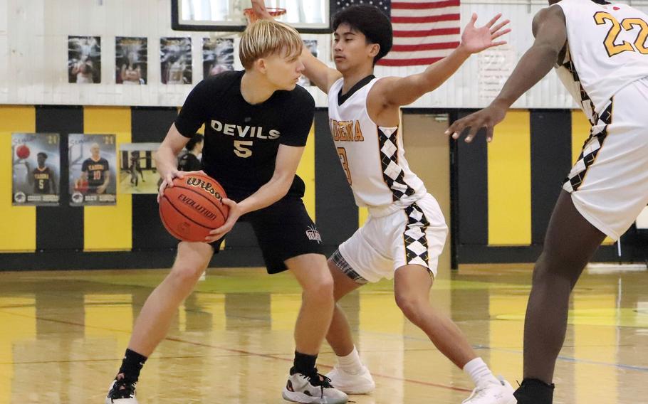 Nile C. Kinnick's Gregor Tolar is guarded by Kadena's Jaden Vergara. The Panthers won 64-62.