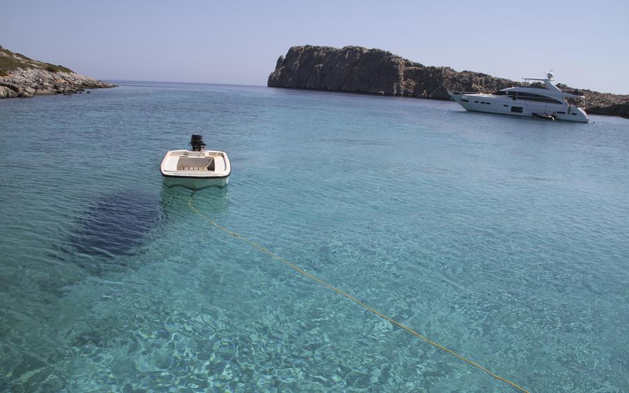 The multihued waters of the Aegean Sea sparkle by the islet of Kounoupa off the island of Astypalea, Greece, on Aug. 30, 2021. 