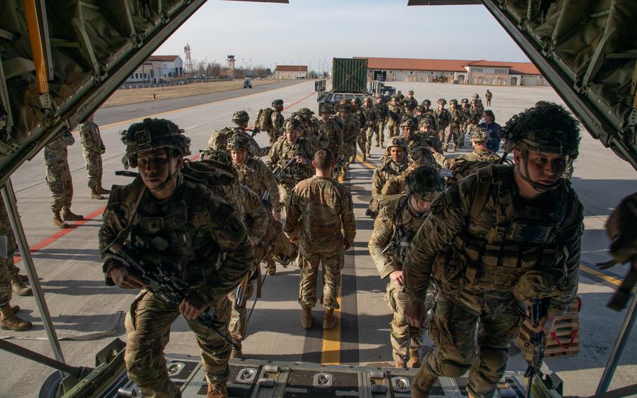 Soldiers and airmen board an aircraft at Aviano Air Base, Italy, Feb. 24, 2022. Quick-turn deployments were examined in a recent Army-sponsored study pointing to potential risks associated with military aid to unstable regions.