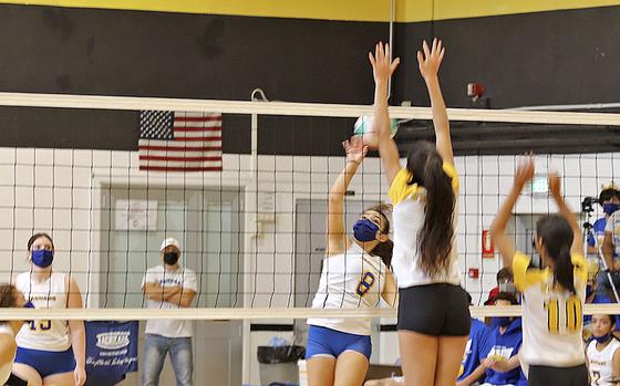 Marley Mcelree of the Sigonella Jaguars, girls volleyball team tries to get the ball over Vicenza Cougars Gabriela Sanchez during Saturday, September 18's game, held at Vicenza High School. The Cougars won in straight games, 25-12, 25-12, and 25-10. Norman Llamas/Stars and Stripes