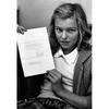A vertical, black and white photo of a girl holding a letter with two hands.