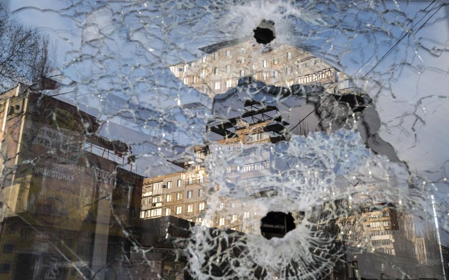 Shrapnel damage is seen in the window of a store in a shopping area in Mykolaiv, Ukraine, on April 5, 2022. 