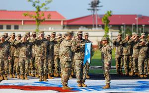 Soldiers assigned to the 528th Military Intelligence Company uncase the unit guidon during their activation ceremony at Camp Humphreys, South Korea, Aug. 5, 2025.