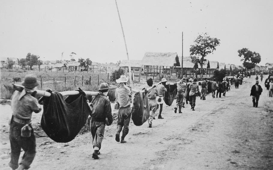 American prisoners using improvised litters to carry comrades in the Philippines, in May 1942. WWII veteran Joseph E. Lescaut, a 21-year-old Cambridge man, was captured during the war and died in 1942 in a POW camp run by Japanese forces in the Philippines. 