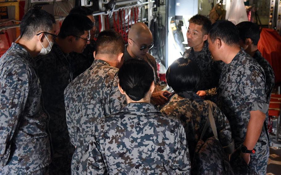 Air Force Capt. Sean Crittenden briefs Japanese airmen ahead of an orientation flight at Yokota Air Base, Japan, May 26, 2023. 