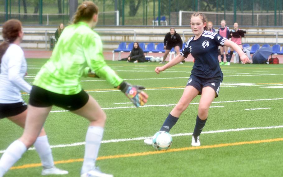 Black Forest Academy’s Anna Yancey shoots onto a wide-open net as AFNORTH goalkeeper Adelle Bown scrambles to get back during a match on April 20, 2024, at Ramstein High School on Ramstein Air Base, Germany.