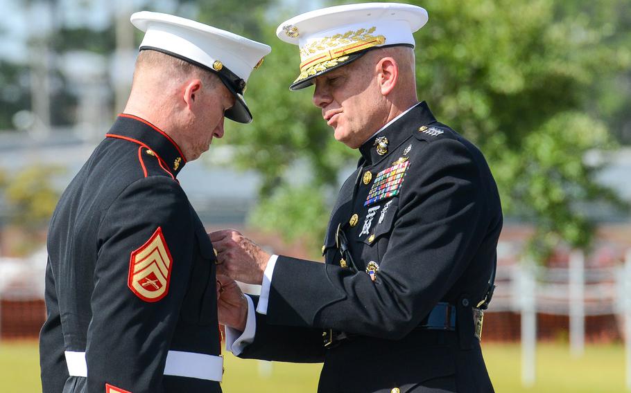 Marine Raider Staff Sgt. Nicholas Jones, left, is presented the Navy Cross by Gen. David Berger, the Marine Commandant, on Thursday, Aug. 26 at Camp Lejeune. Jones, a member of the elite 2nd Marine Raider Battalion was awarded the nation’s second highest medal for battlefield heroics for his actions in a deadly fight with Islamic State group militants in Iraq in March 2020.
