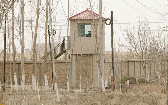 A security guard watches from a tower around a detention facility in Yarkent County in northwestern China's Xinjiang Uyghur Autonomous Region on March 21, 2021. As world leaders gather in New York at the annual U.N. General Assembly, rising superpower China is also focusing on another United Nations body that is meeting across the Atlantic Ocean in Geneva.