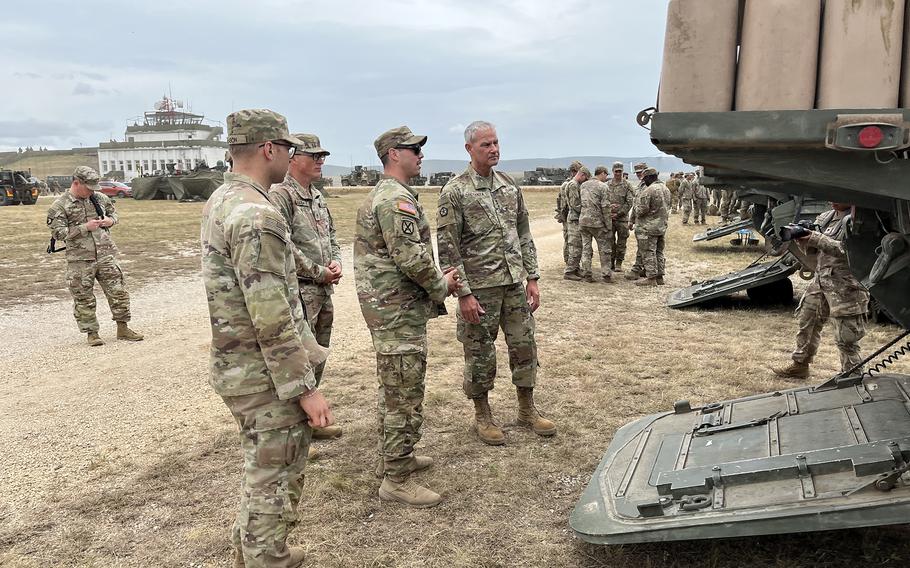 A Stryker gunner shows off his vehicle during exercise Saber Guardian.