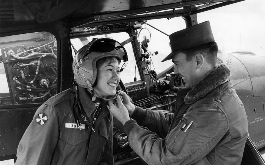 A woman tries on a helmet