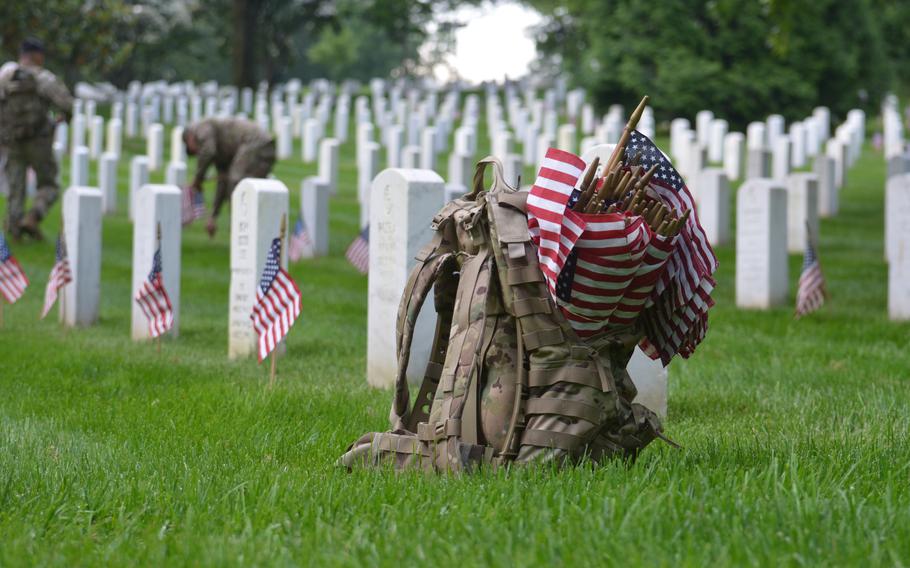 Members of the 3rd Infantry Regiment, also known as The Old Guard, place flags at the graves of those buried at Arlington National Cemetery for “Flags In” on Thursday, May 23, 2024, to honor fallen service members for Memorial Day. It is an annual event the regiment has conducted since being designated as the Army’s official ceremonial unit in 1948. 