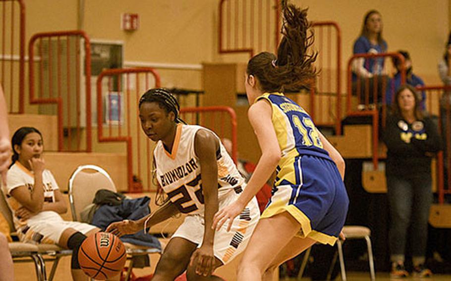 Baumholder’s Adrianna Lopez dribbles past Sigonella's Fabiola Mercado-Rodriguez during a DODEA-Europe Division III basketball semifinal game Feb. 17, 2023, in Baumholder, Germany.