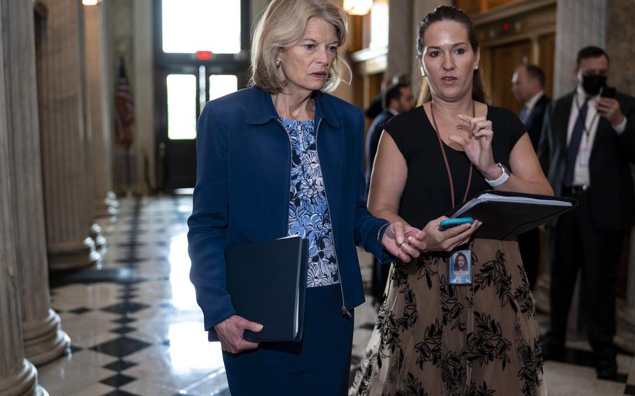 Sen. Lisa Murkowski, R-Alaska, speaks to an aide as senators arrive before a procedural vote on the Women’s Health Protection Act to codify the landmark 1973 Roe v. Wade decision that legalized abortion nationwide, at the Capitol in Washington, Wednesday, May 11, 2022. President Joe Biden called on Congress to pass legislation that would guarantee the constitutional right to abortion services after the disclosure of a draft Supreme Court opinion that would overturn Roe v. Wade.