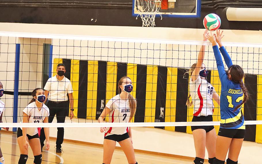Jaycee Spence of the Aviano Saints goes up for a kill with Fabiola Mercado-Rodriguez  of the Sigonella Jaguars trying to block Saturday, Oct. 30, 2021, during the DODEA-Europe Division II tournament in Vicenza, Italy.