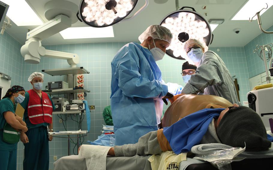 General surgeons Air Force Maj. Katherine Cameron, right, and Lt. Col. Joachim Sahm of the German military practice operating during a mass casualty response drill at Landstuhl Regional Medical Center in Germany, March 10, 2022.