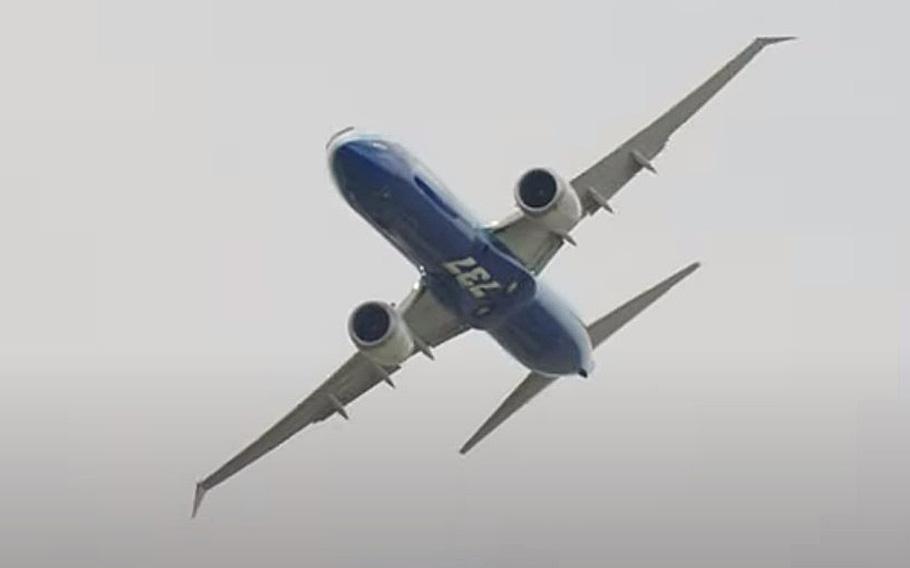 A video screen grab shows a Boeing 737 MAX performing at a Paris Air Show.