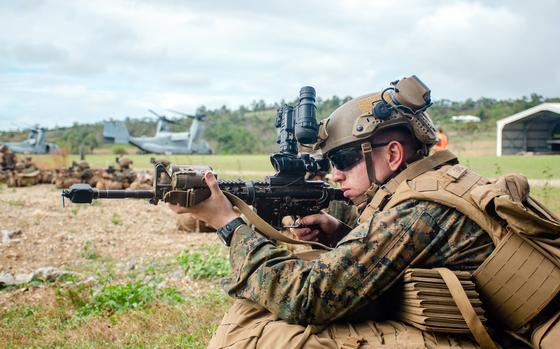 A U.S. Marine posts security during an uncontested air-assault exercise at Bloomsbury Airfield in Midge Point, Australia, Friday, June 28, 2023.