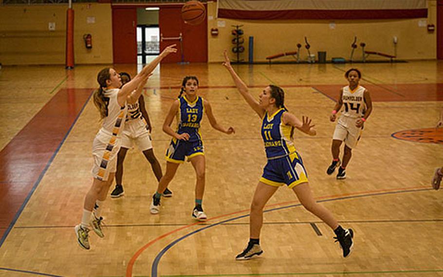 Baumholder’s Gabrielle Williams launches a three-pointer as Sigonella's Julie Spencer defends during a DODEA-Europe Division III basketball semifinal game Feb. 17, 2023, in Baumholder, Germany.