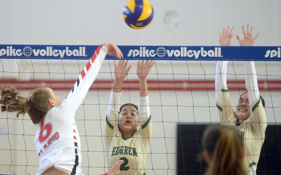 E.J. King's Madylyn O'Neill spikes against Robert D. Edgren's Isa Tackney and Christina Goodson.