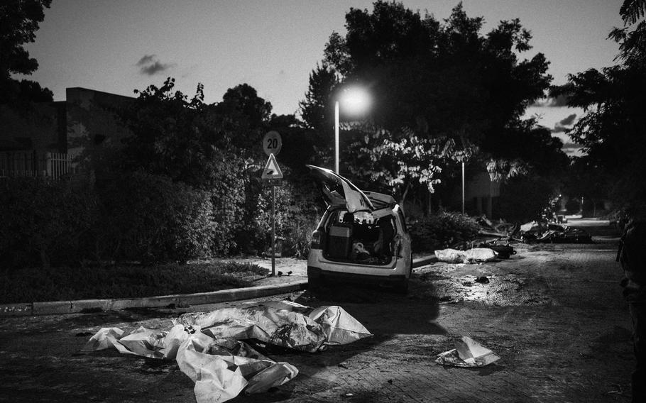 Bodies remained on a road in Kibbutz Beeri on Oct. 11 2023.