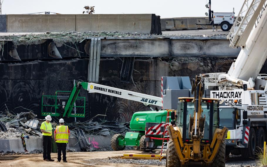 Workers inspect and clear debris on June 15, 2023. 