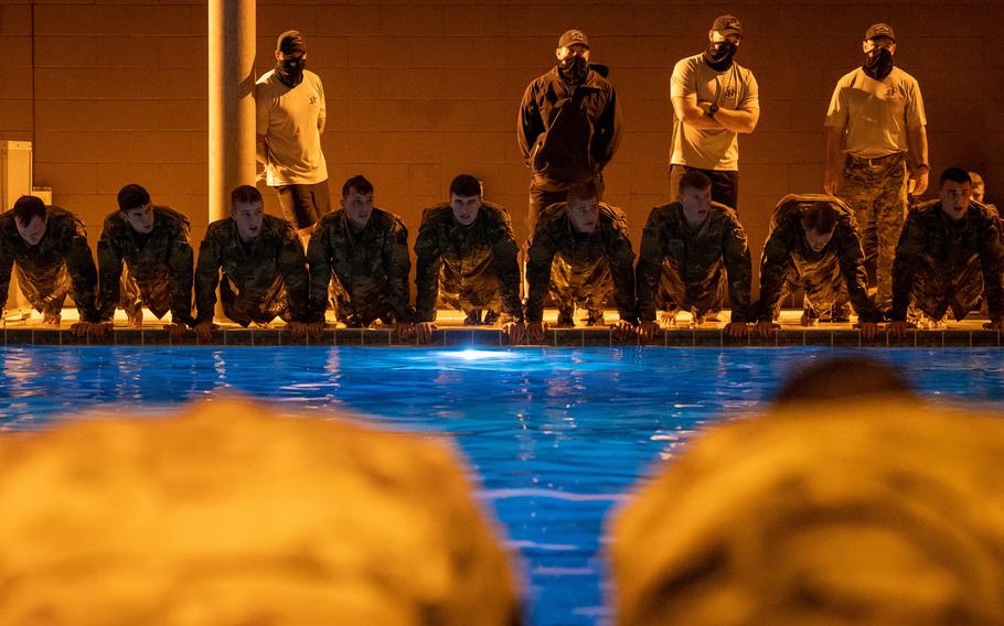 U.S. Air Force special tactics and combat rescue officer candidates do 10-ups at the edge of a pool at Hurlburt Field, Fla., on March 24, 2021. 