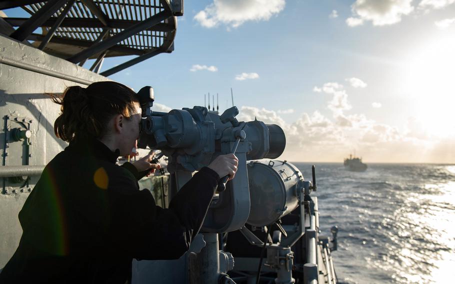 A sailor aboard the guided-missile cruiser USS Monterey looks out at the Mediterranean Sea, March 17, 2021. 