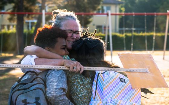 Children from Grafenwoehr Elementary School are greeted by fourth-grade teacher Nell Dunn, Aug. 22, 2022, in Grafenwoehr, Germany.